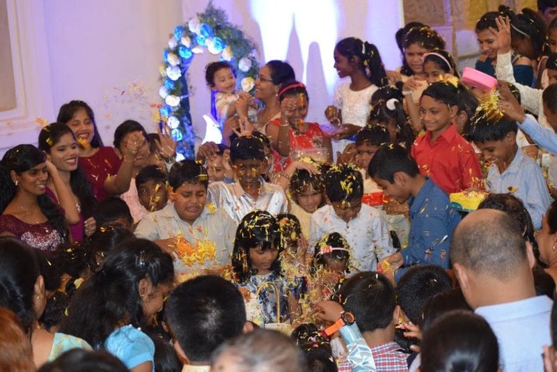 Children showering flower petals on Our Lady's Statue