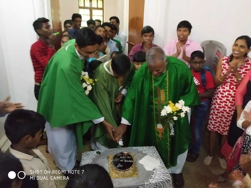 The congratulatory cake being ceremonially cut to mark the occasion